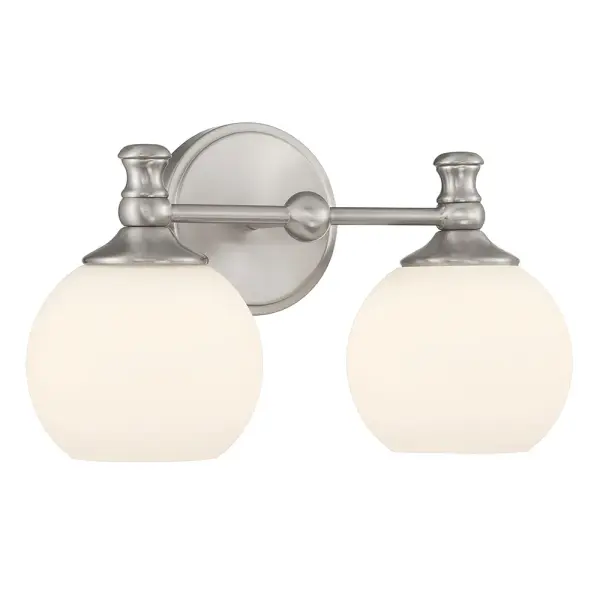 The Orlisse vanity bar beautifully blends timeless Edwardian design with contemporary clean lines. Etched opal globes provide soft, flattering illumination while antique-style finials add refined detail.