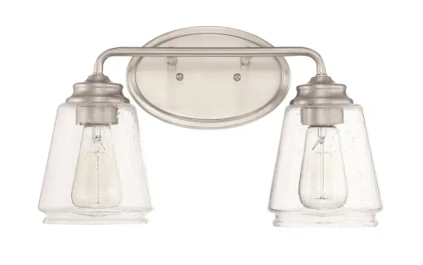 The 2462 vanity light offers a clean, transitional design in brushed nickel that complements a wide range of bathroom styles. Its neutral finish and wall-mounted configuration make it ideal for residential and commercial applications.