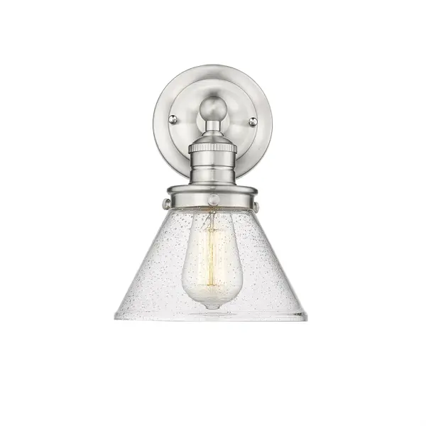 The 4141 wall sconce in brushed nickel offers a clean, timeless aesthetic that complements both contemporary and traditional interiors. Its neutral metallic finish provides versatile styling options.