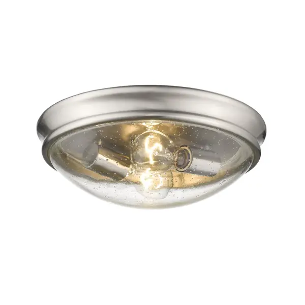 This flush mount fixture combines textured threaded glass with a refined brushed nickel finish, offering a sophisticated lighting solution for low-ceiling spaces. Its compact profile and neutral aesthetic work seamlessly across traditional and contemporary interiors.