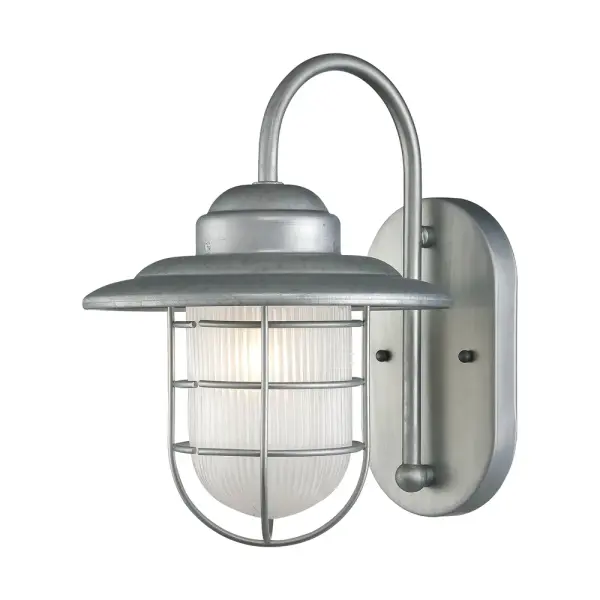 This industrial-style outdoor wall light features a galvanized finish designed for wet locations. Perfect for porches, patios, and entryways where weather resistance is essential.