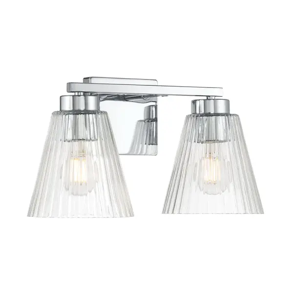 The Rivelle vanity light combines crisp angular lines with clear striated glass for a distinctive modern aesthetic. Its minimalist chrome finish and dappled glass effect create sophisticated illumination perfect for contemporary bathrooms.