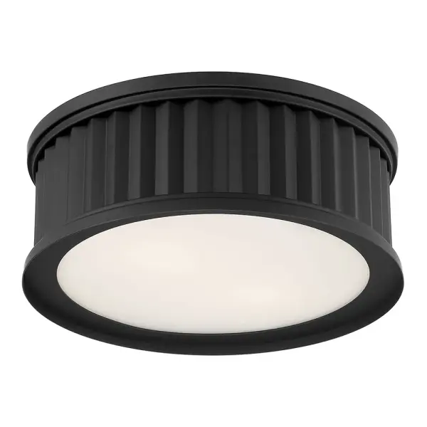The Corvella flush mount combines striking corrugated metalwork with a matte black finish and opaque white diffuser for a perfect blend of industrial edge and gentle illumination in modern spaces.