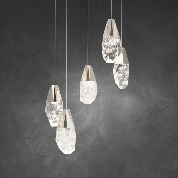 A shower of jewels. Suspended in mid-air, Schonbek Optic Crystal and Optic Haze Quartz elements composed of natural quartz gemstone illuminate at varying heights to entice. Cascading from above and perfectly designed to make a powerful yet elegant statement.