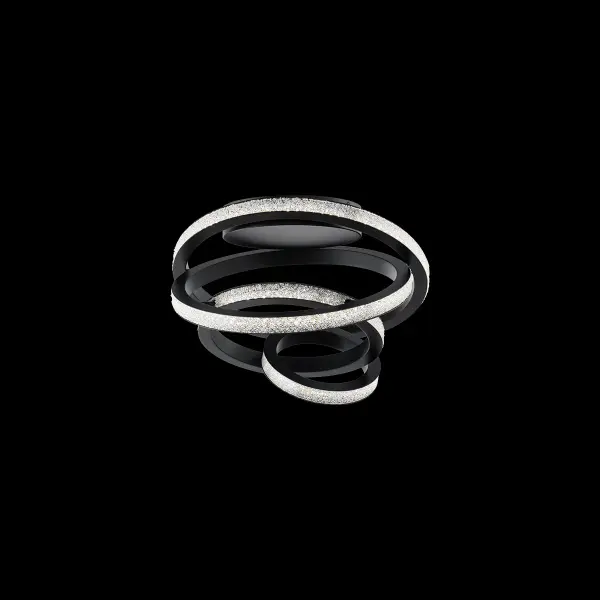 Twisted. A curvy black metallic frame embraces a sparkling Radiance® Crystal Dust diffuser, capturing and casting a glowing vortex of light.