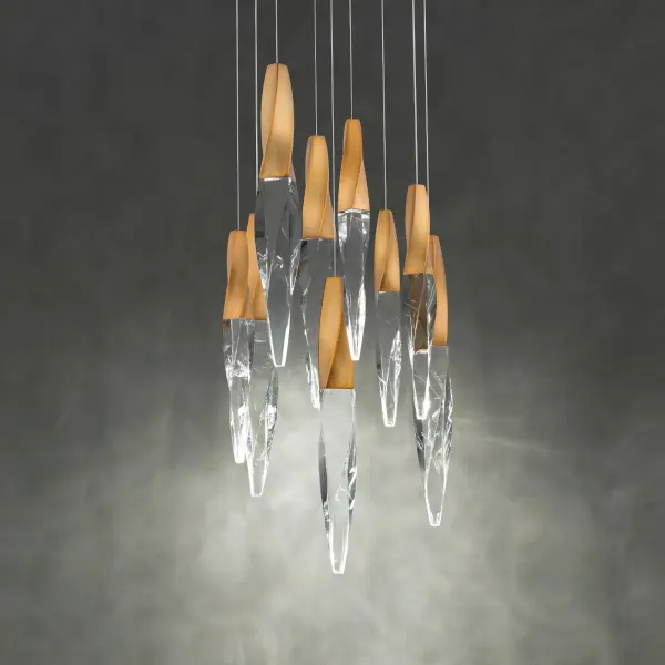 A subtle twist of luxe. Kindjal features exquisite Optic Crystal icicles that twist to a point from a cohesive metal casting, concealing a powerful LED that provide ample illumination. Stylish, textured materiality.
