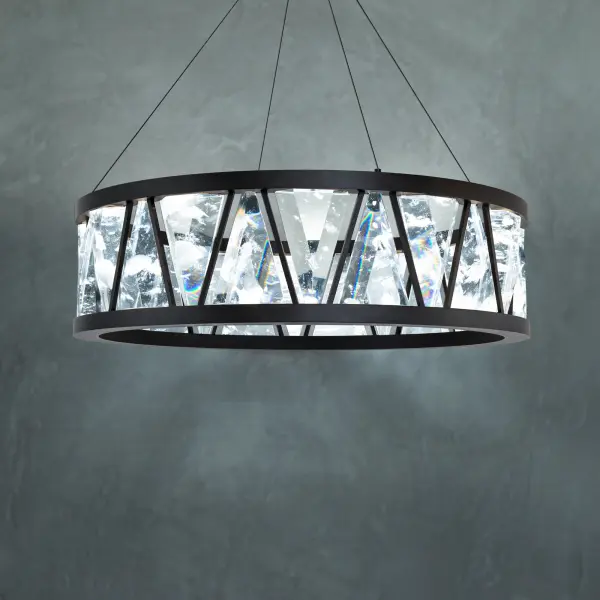 Adorned with with large trillion-diamond shaped Schonbek Optic Haze® Quartz that mimic natural quartz gemstones. Corinth is a new statement on crystal. Hidden light sources and powered aircraft cables elevate a conservative profile with intrigue and technology. The solid double ring body is finished in quartz Haze® and deploys ambient up lighting.