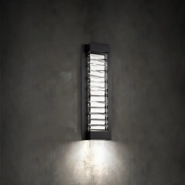 A faceted abstract design of solid Optic Crystal. Hidden LEDs illuminate the crystal internally and also provide downlight for wayfinding on this interior wall sconce.