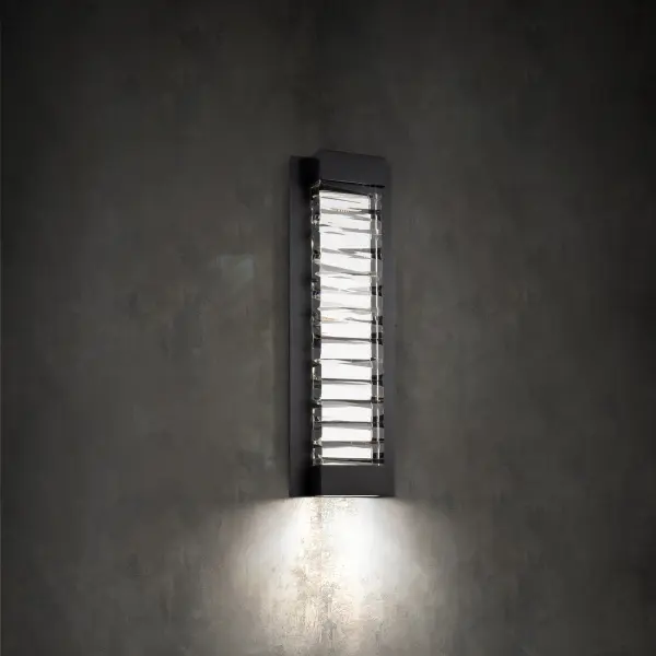 A faceted abstract design of solid Optic Crystal. Hidden LEDs illuminate the crystal internally and also provide downlight for wayfinding on this interior wall sconce.