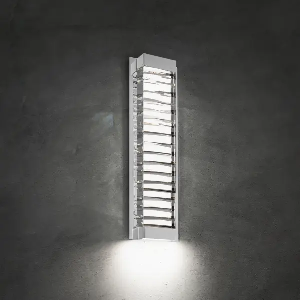 A faceted abstract design of solid Optic Crystal. Hidden LEDs illuminate the crystal internally and also provide downlight for wayfinding on this interior wall sconce.