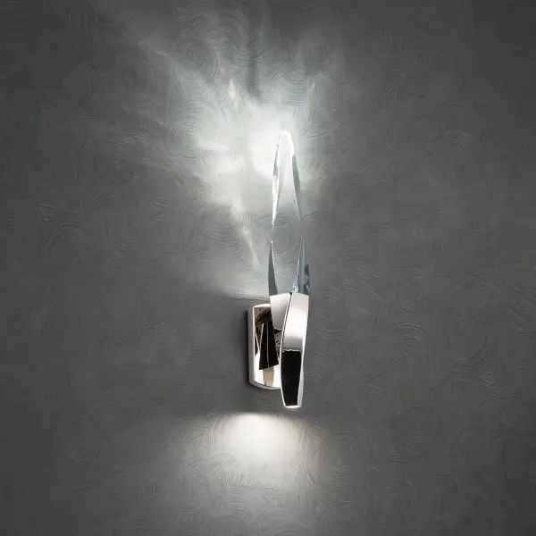 A subtle twist of luxe. Kindjal features exquisite Optic Crystal icicles that twist to a point from a cohesive metal casting, concealing a powerful LED that provide ample illumination. Stylish, textured materiality.