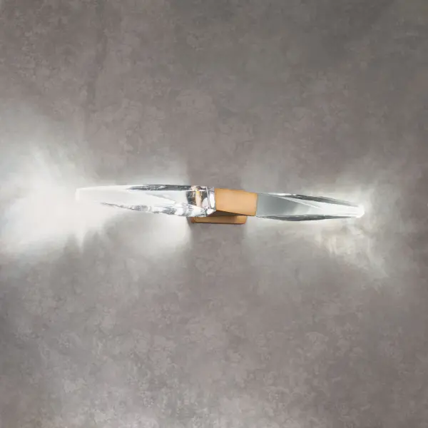 A subtle twist of luxe. Kindjal features exquisite Optic Crystal icicles that twist to a point from a cohesive metal casting, concealing a powerful LED that provide ample illumination. Stylish, textured materiality.