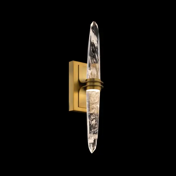 Pickwick brings a striking vertical elegance to contemporary spaces with its elongated, stiletto-inspired profile. A faceted Optic Haze® Quartz crystal forms the centerpiece—its organic veining and subtle translucence illuminated beautifully by color-selectable 4CCT LEDs. A raised, banded metal detail cinches the crystal at the center, adding sculptural refinement and a sense of poised tension.