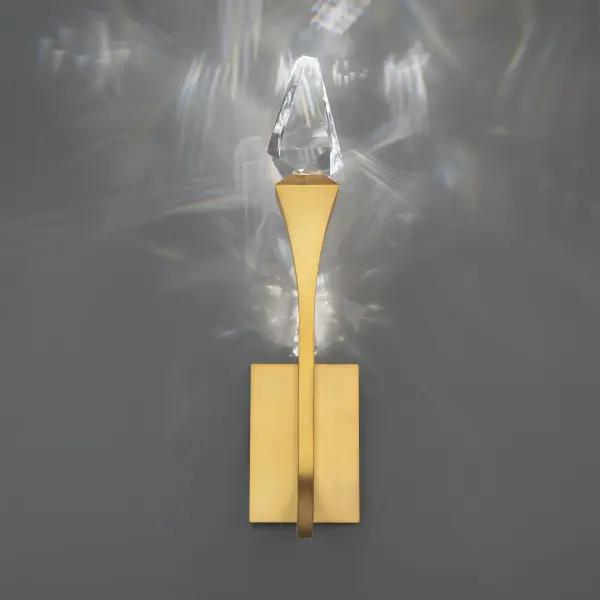 Like an architectural marvel, sparkling tapered crystal elements crown the ends of sleek, curving arms in an elegant composition. LED illumination filters through the faceted crystal, reflecting off the polished arms to create a stunning, ambient glow that fills the space with brilliance.