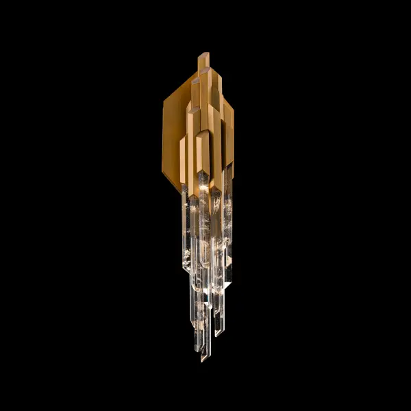 Organza channels the bold geometry and glamour of Art Deco through a breathtaking interplay of metal and crystal. Layered Optic Haze® Quartz rods framed by metallic accents descend in a cascading formation, each one illuminated by a hidden lihgt source. As light filters through the natural stone, subtle variations in luster, hue, and texture emerge, creating a mesmerizing glow.