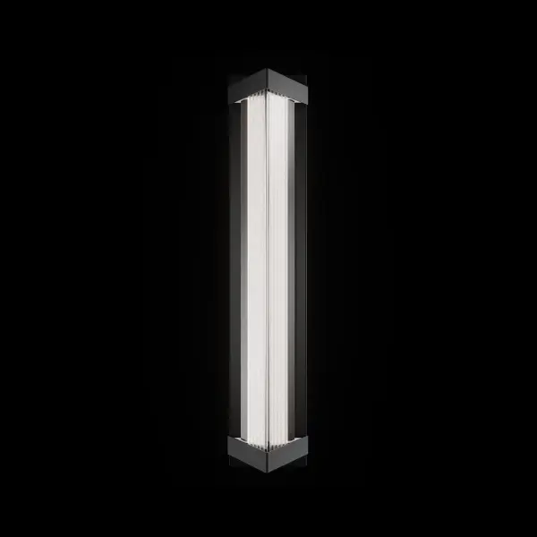 Bertram elevates outdoor lighting with a striking triangular profile that frames an illuminated column of saw-cut Optic Crystal. The crisp facets scatter light with shimmering precision, while the streamlined metal structure adds modern architectural strength.