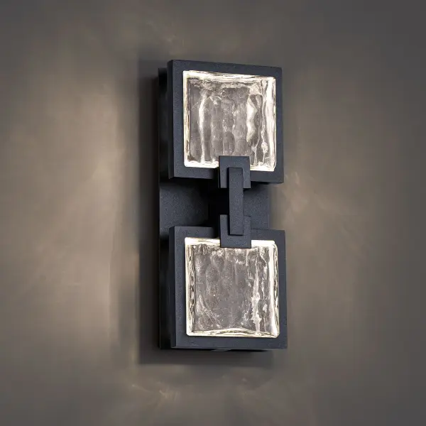 Meet Pop Star—an outdoor wall light that thrives on performing. Three square crystal panels each etched with a striking starburst pattern, are secured by sleek metallic accents against a rectangular aged brass backplate. Concealed LEDs edge-light each incised square, creating an ambient glow that highlights every detail. Finished with a weather-resistant powder coat, this piece is built to command attention, rain or shine.