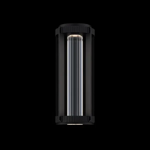 Gainey offers a strikingly modern interpretation of the traditional lantern silhouette. A solid Optic Crystal cylinder, cut with precise V-grooved facets, anchors the design, refracting illumination into clean vertical lines that echo the structure’s architectural form. Framing the crystal, a refined metal enclosure with knurled detailing at the top and bottom adds tactile depth and a subtle industrial edge.