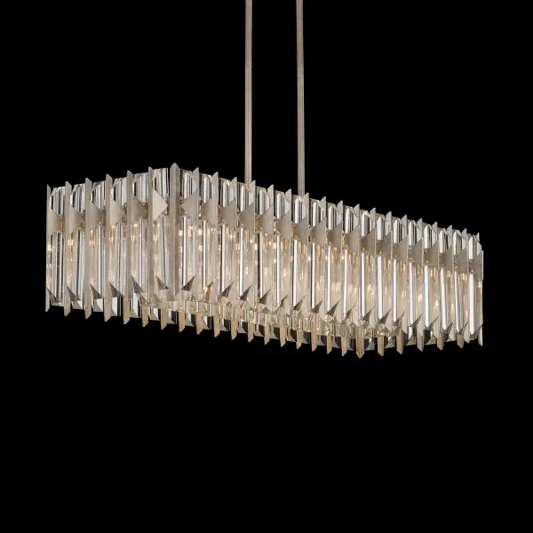 With sculptural grace and refined geometry, Terina celebrates light through precision-cut Optic crystal. Elongated triangular bars form a rhythmic, architectural composition within a streamlined metal frame, capturing and refracting light from every angle to create a mesmerizing interplay of brilliance and shadow.