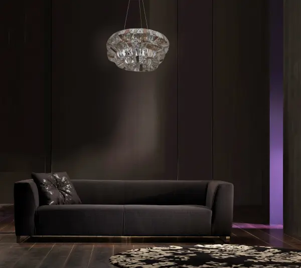 This dramatic 31-inch pendant draws inspiration from Frank Gehry's iconic architectural style, featuring an eclectic framework adorned with faceted rectangular crystals in clear and bronze tones, complemented by metallic panels. - alternate view