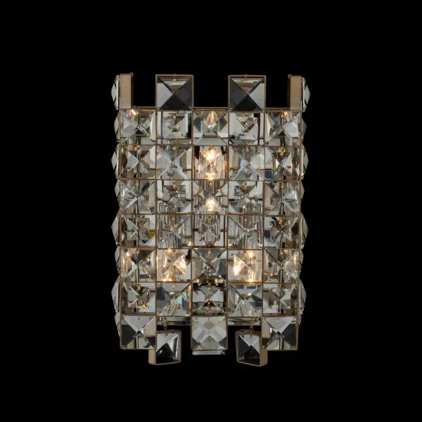 The Piazze wall sconce features faceted crystal squares in a sophisticated checkered pattern, framed in brushed champagne gold. Its use of negative space creates visual lightness while delivering upscale appeal for both formal and casual interiors.