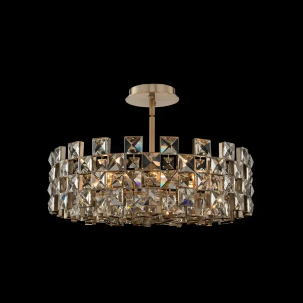 The Piazze pendant features faceted crystal squares arranged in an elegant checkered pattern within a brushed champagne gold frame. Its use of negative space creates visual lightness while maintaining formal elegance.