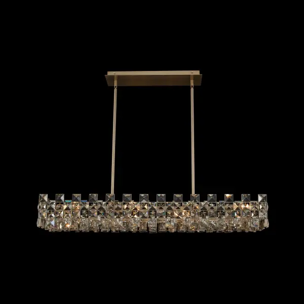 The Piazze 44" Island Pendant features faceted crystal squares arranged in an elegant checkered pattern within a Brushed Champagne Gold frame. Its use of negative space creates visual lightness while maintaining luxury appeal.