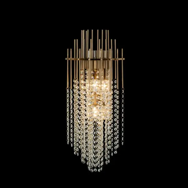 The Estrella Wall Sconce features slender metal rods holding delicate faceted crystal beads for a dramatic, artistic look. Its Brushed Champagne Gold finish brings glamorous warmth to modern interiors.