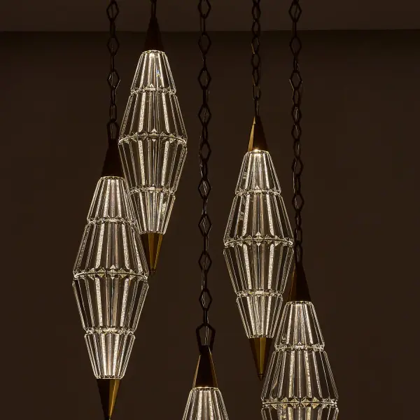 The Allungato pendant is a breathtaking architectural lighting sculpture featuring innovative double mirror film crystals that reflect by day and illuminate by night. At 30 inches wide and up to 140 inches tall, this dramatic piece commands attention in grand spaces. - alternate view