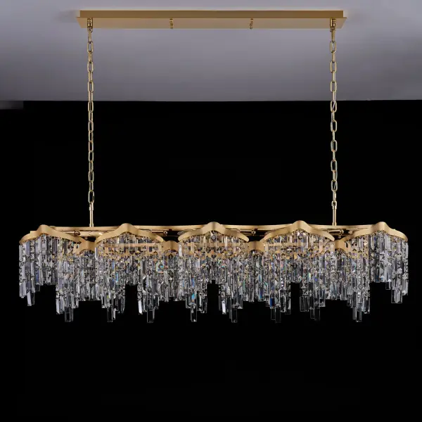 The Cadere Island Light transforms spaces with cascading Firenze Crystals suspended from an undulating gold frame. At 63 inches long, this statement piece brings dramatic elegance to large dining rooms and kitchen islands. - alternate view