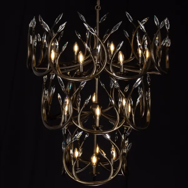 The Chalet Chandelier reimagines traditional antler design with forged steel construction and layered interwoven rings. Crystal points add shimmer while the Dark Pearlized Antique Brass finish brings warmth to modern lodge or contemporary spaces. - alternate view