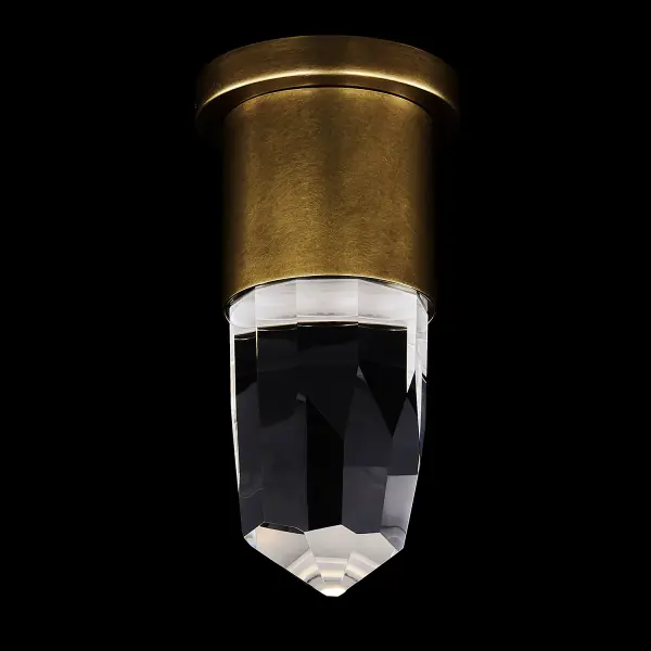 The Ore wall sconce combines faceted crystal with warm brass finish to create stunning light refraction patterns. Its compact 5-inch profile and dual-mount capability make it versatile for various spaces while delivering 560 lumens of warm LED light.