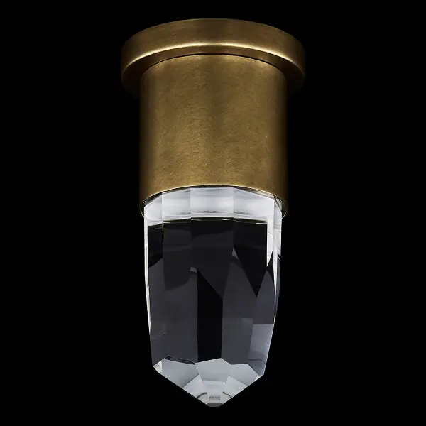 The Ore wall sconce combines faceted crystal with warm brass finish to create stunning light refraction patterns. Its compact 5-inch profile and dual-mount capability make it versatile for various spaces while delivering 560 lumens of warm LED light. - alternate view