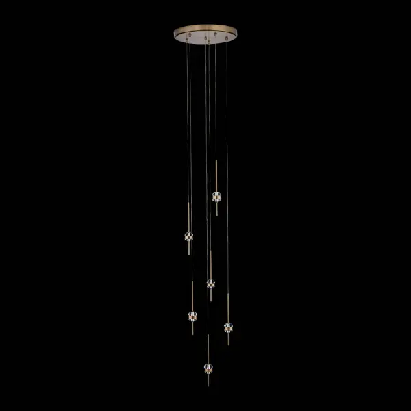 The Goccia chandelier transforms any space with its jewelry-inspired design, featuring oversized crystals pierced by a Winter Brass frame. Integrated LED lighting creates captivating sparkle with both up and down illumination.
