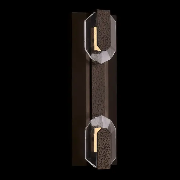 The Opposto Esterno combines concealed LED lighting with Firenze crystal and hammered stainless steel in a durable Bronze Fluorocarbon finish. WET-rated for outdoor use, this modern sconce creates captivating light play through crystal reflections.