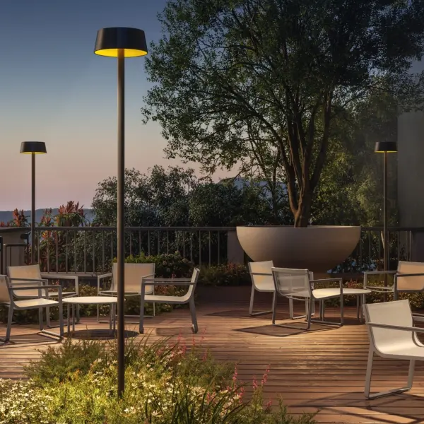 The Sundress combines sophisticated Italian design with sustainable solar technology. Standing over 9 feet tall, this cordless pole light features dual diffusers and automatic daylight sensing for effortless outdoor illumination.
