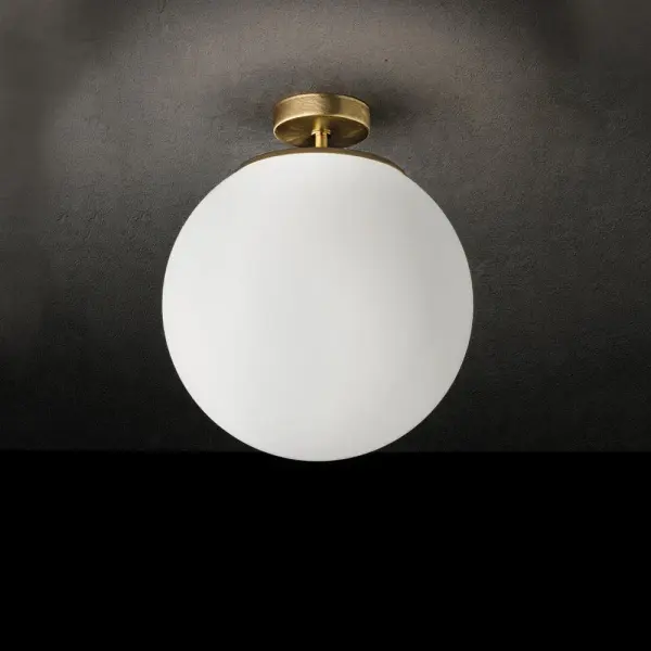 The Sferis Classic delivers sophisticated minimalist design with its curved translucent globe that eliminates shadows and hot spots. The brushed brass finish adds warmth while the streamlined silhouette suits contemporary spaces. - alternate view