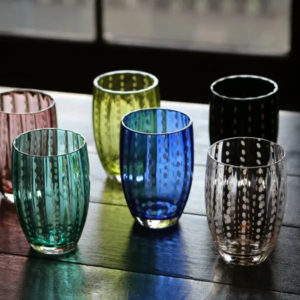 The Perle tumbler set brings artisanal elegance to your table with six handcrafted transparent glasses featuring delicate white decorations. Perfect for summer long drinks and special occasions alike. - alternate view