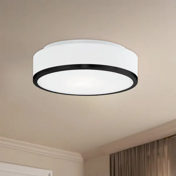 The Charlie flush mount combines minimalist black metal trim with white opal glass for a contemporary look that works in various spaces. Its compact 12-inch profile makes it ideal for rooms with lower ceilings or smaller footprints. - alternate view