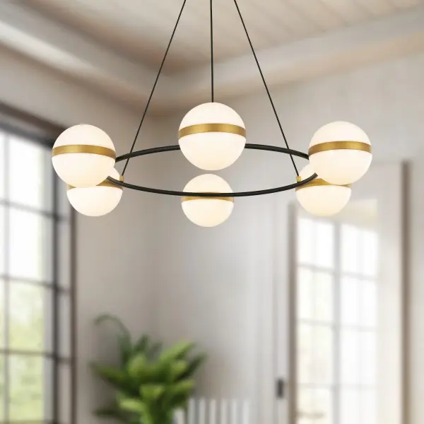 The Tagliato chandelier masterfully combines matte black frames with brushed gold accents for a striking transitional aesthetic. Featuring integrated LED opal globes with warm 3000K lighting, this 36-inch fixture delivers both style and energy efficiency for medium to large spaces. - alternate view