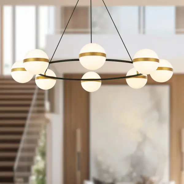 The Tagliato chandelier masterfully combines matte black frames with brushed gold accents for a striking transitional aesthetic. Featuring integrated LED opal globes with warm 3000K lighting, this 44-inch fixture delivers both style and function. - alternate view