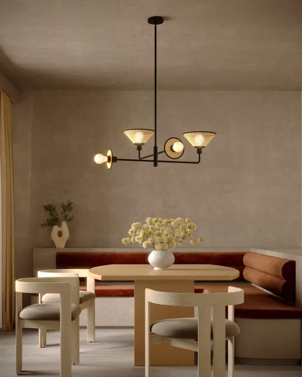 The Piper chandelier makes a striking statement with its unique asymmetrical design and natural rattan cane shades. The Brushed Gold finish adds warmth and sophistication, while the organic materials bring texture and personality to any space. - alternate view