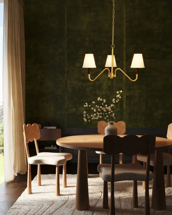 The Sloan Chandelier masterfully combines traditional silhouettes with contemporary details. Soft white linen shades create warm, inviting illumination while textured arms and chain accents add visual depth and character. - alternate view