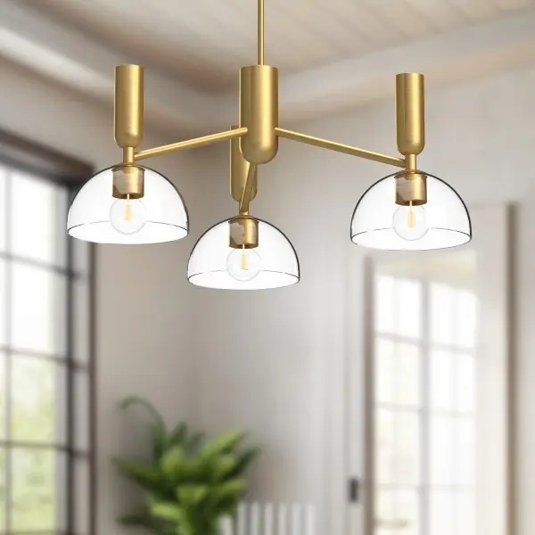 The Jude chandelier combines geometric stems with organically curved details for a unique artistic presence. Its half-dome glass shades and hourglass silhouette create visual interest while the brushed gold finish adds warmth. - alternate view