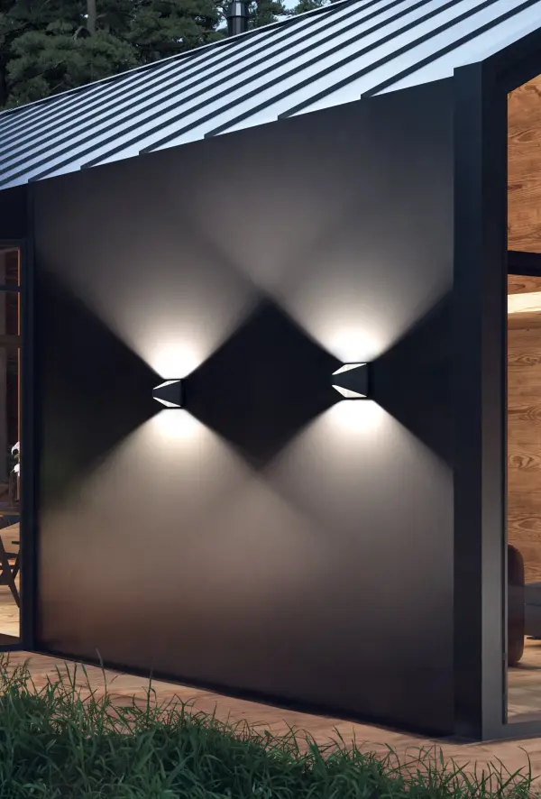 The Ellis wall sconce delivers contemporary style with practical durability for outdoor spaces. Its triangular design provides both upward and downward illumination, while IP65 rating ensures weather resistance. - alternate view