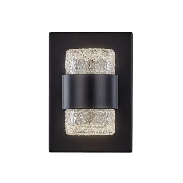 The Copenhagen wall sconce combines clean geometric lines with detailed translucent glass for a refined outdoor lighting solution. Its integrated LED provides warm illumination while the black finish adds contemporary elegance.