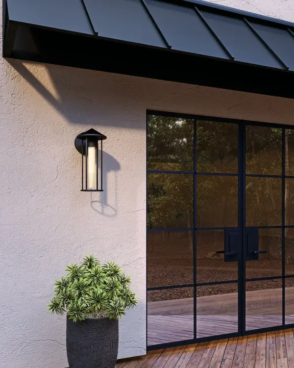 The Tenko wall sconce blends Japanese and Craftsman architectural details with modern minimalism. Its glossy opal glass maximizes luminosity for a soft lantern-like glow, while clean metal lines create timeless appeal for any exterior or interior space. - alternate view
