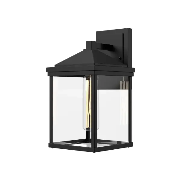 The Larchmont Wall Sconce brings timeless Spanish Colonial charm to outdoor spaces with a contemporary minimalist twist. Its textured black finish and clear glass shade create beautiful ambiance while maintaining clean lines.