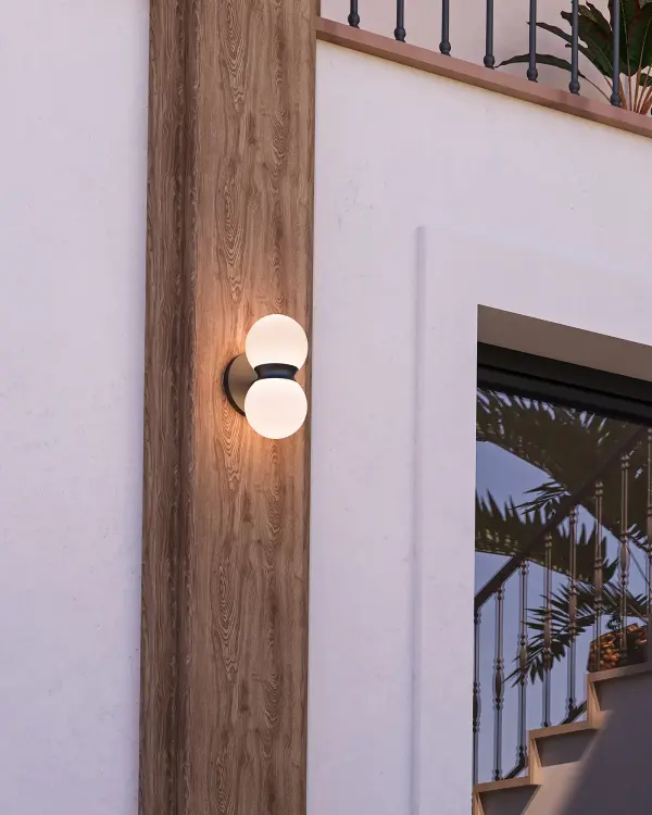 The Peri exterior wall sconce combines contemporary minimalist design with practical outdoor functionality. Its matte black finish and choice of ribbed or opal glass create sophisticated ambiance while integrated LED technology ensures energy efficiency and longevity. - alternate view