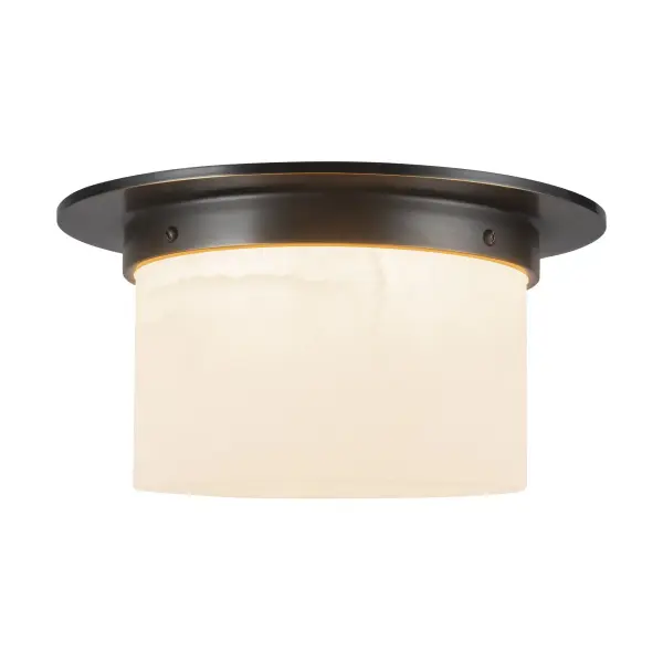 Jason Koharik's Mineral collection brings sculptural sophistication to compact spaces. The 5-inch flush mount pairs patina brass framing with luminous opal glass, creating a soft, textural glow perfect for hallways and intimate rooms.